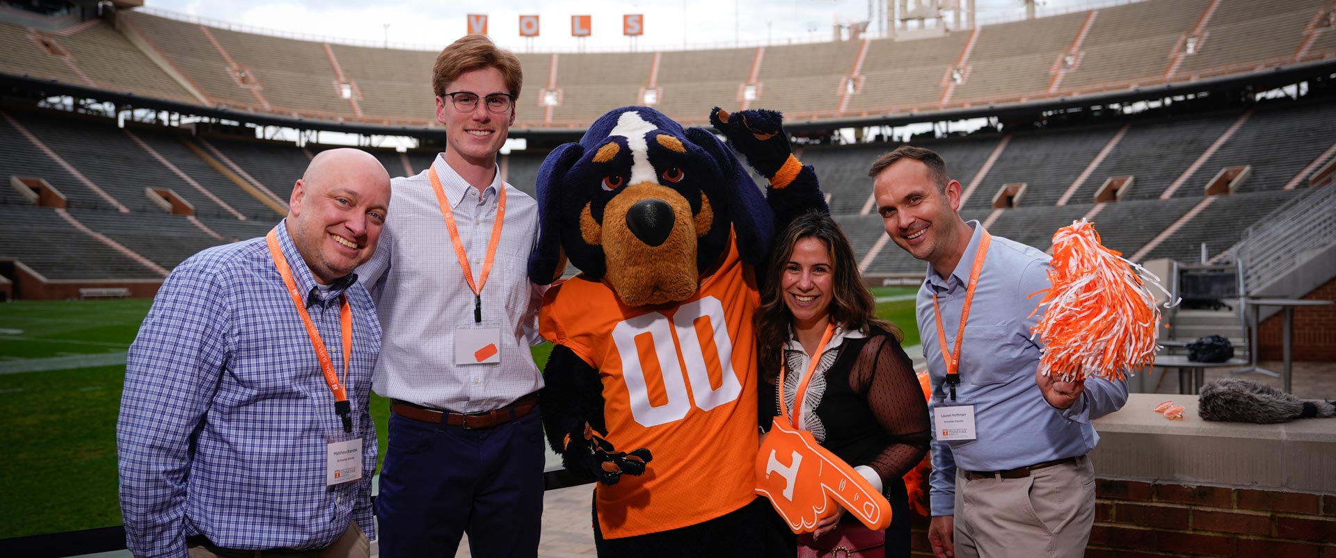 Group of people with Smokey mascot in Neyland Stadium