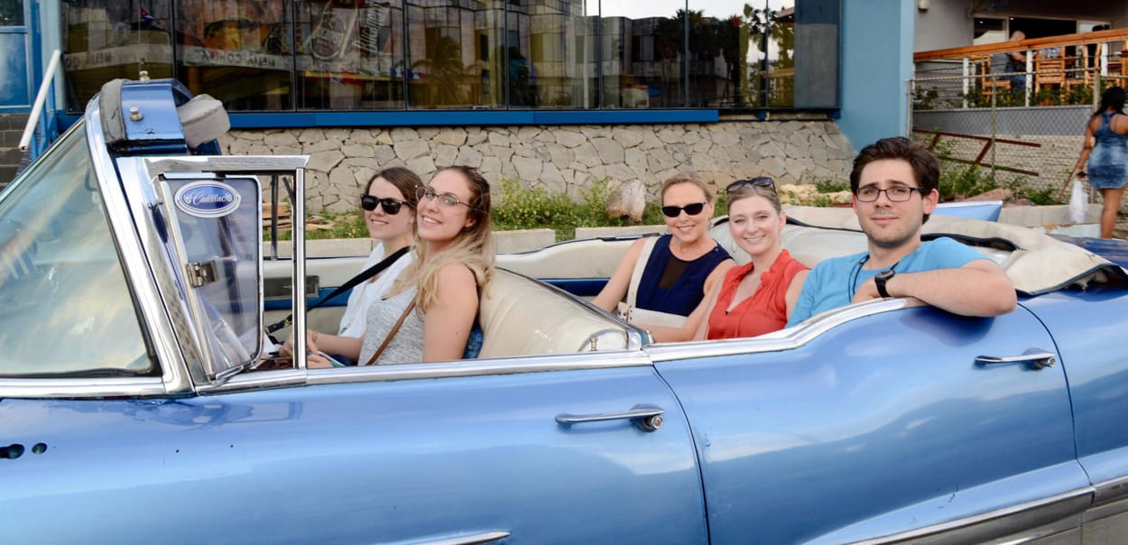 Students in Cuba in a car