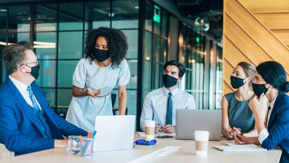 People in a meeting wearing masks