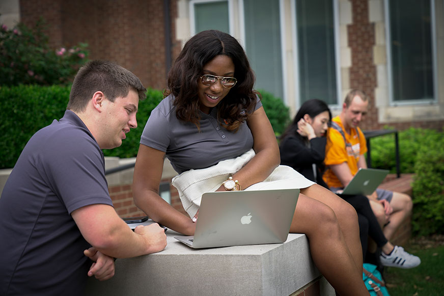 BAS Undergraduates outside on laptop