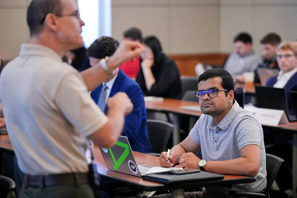 Student listening to teacher in classroom