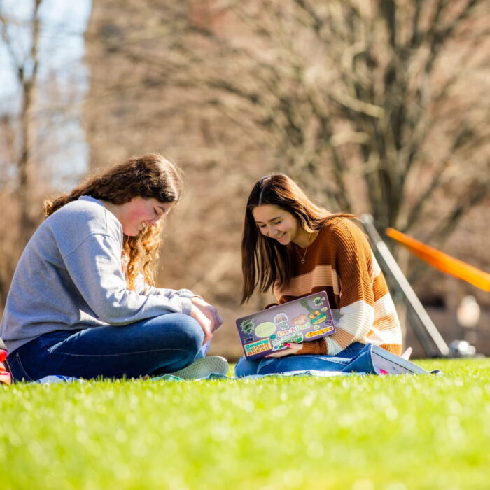 Students studying on grass outside