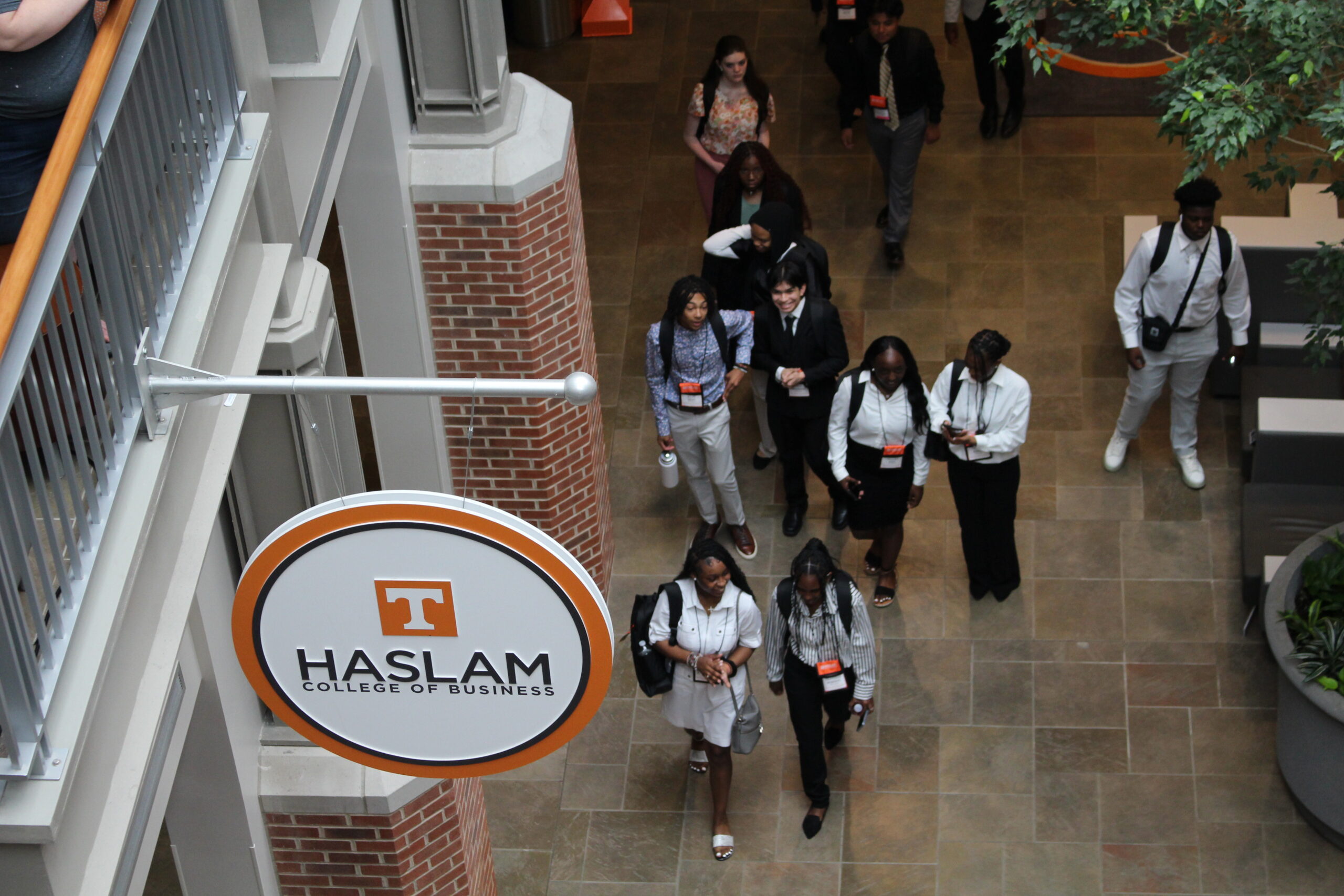 Students walking in the atrium with Haslam sign