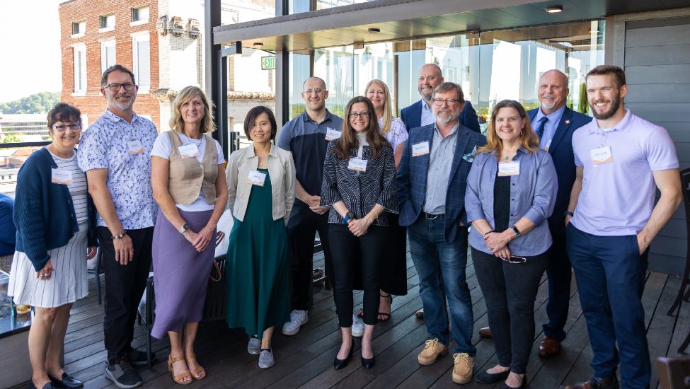 The 2024-2025 ACEI Fellows pose at a rooftop reception in downtown Knoxville.