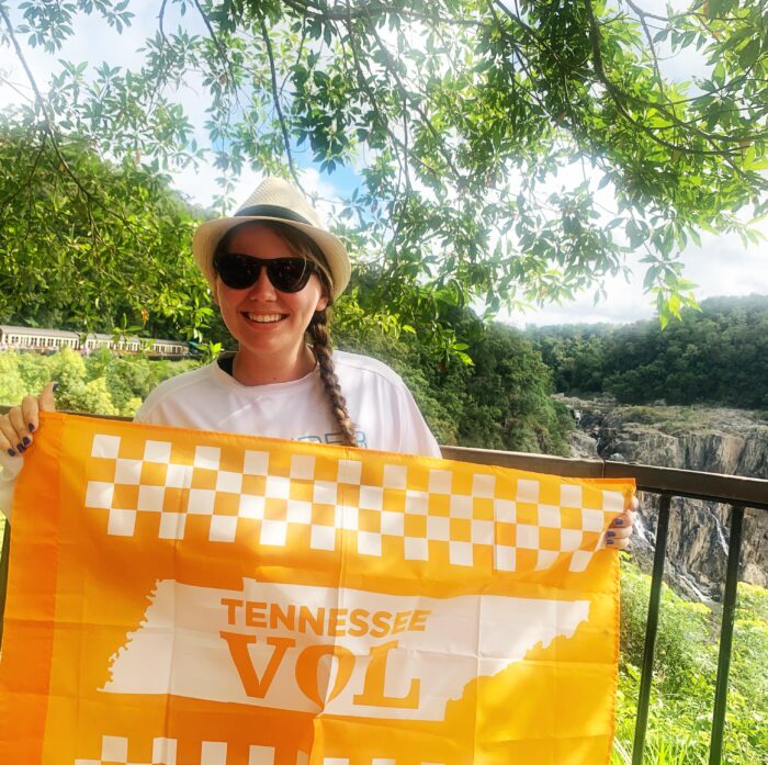 woman holding a Tennessee Vol flag