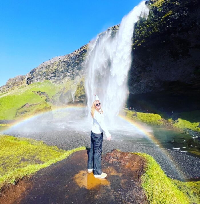 Woman in front of waterfall