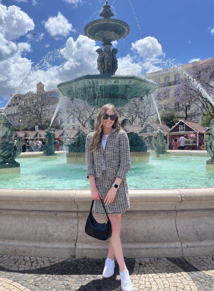 woman in front of a fountain