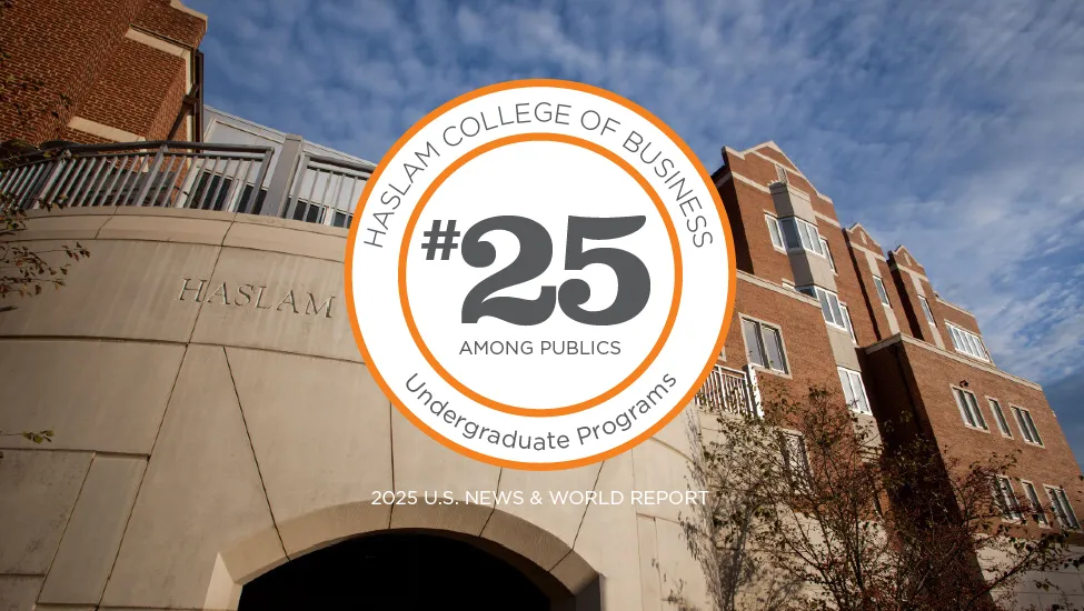 A round emblem lined with orange on a white background features the words "Haslam College of Business, #25 Among Publics, Undergraduate Programs" in black on it with 2025 U.S. News & World Report in white below the emblem. This is superimposed on skyward-looking photo of the Haslam Business Building's south balcony, thin white clouds streaming above it/