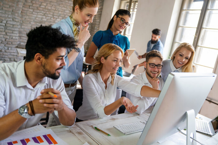 Group of office workers at a computer