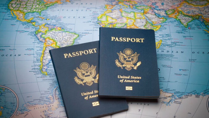 Two U.S. passports lie atop a world map.