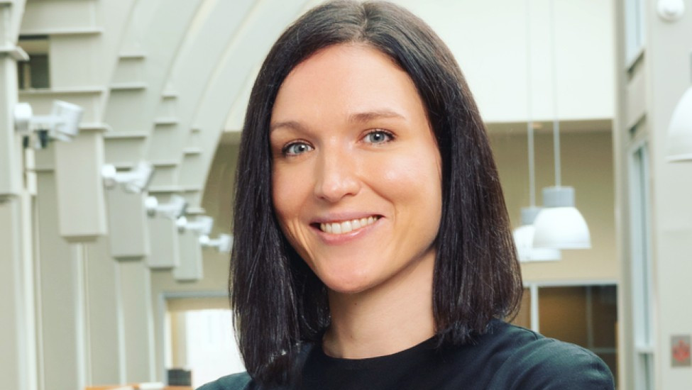 Portrait image of Ruta Ruzeviciute in a black blouse in the Haslam Business Building atrium