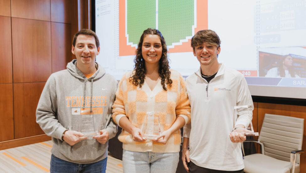 Ben Northern, Sarah Chandler and Beckett Anderson pose with glass trophies