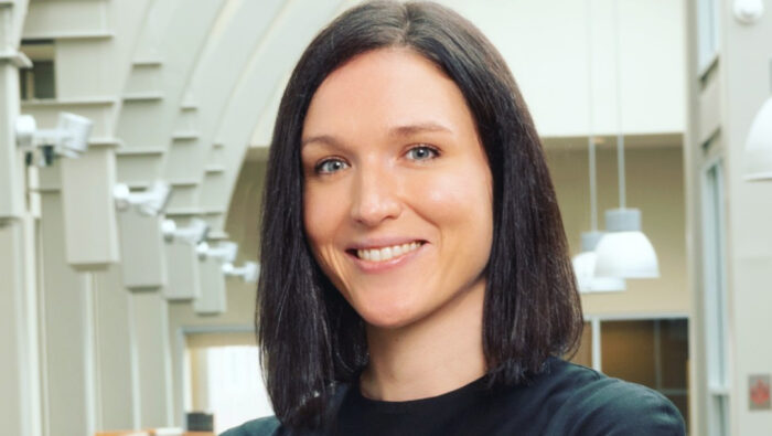 Portrait image of Ruta Ruzeviciute in a black blouse in the Haslam Business Building atrium|Portrait image of Ruta Ruzeviciute in a black blouse in the Haslam Business Building atrium