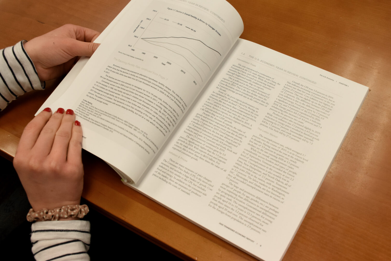 Alannah Shute leafs through the Boyd Center's 2024 Economic Report to the Governor