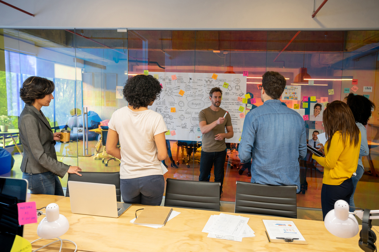 Team of UT students working a whiteboard