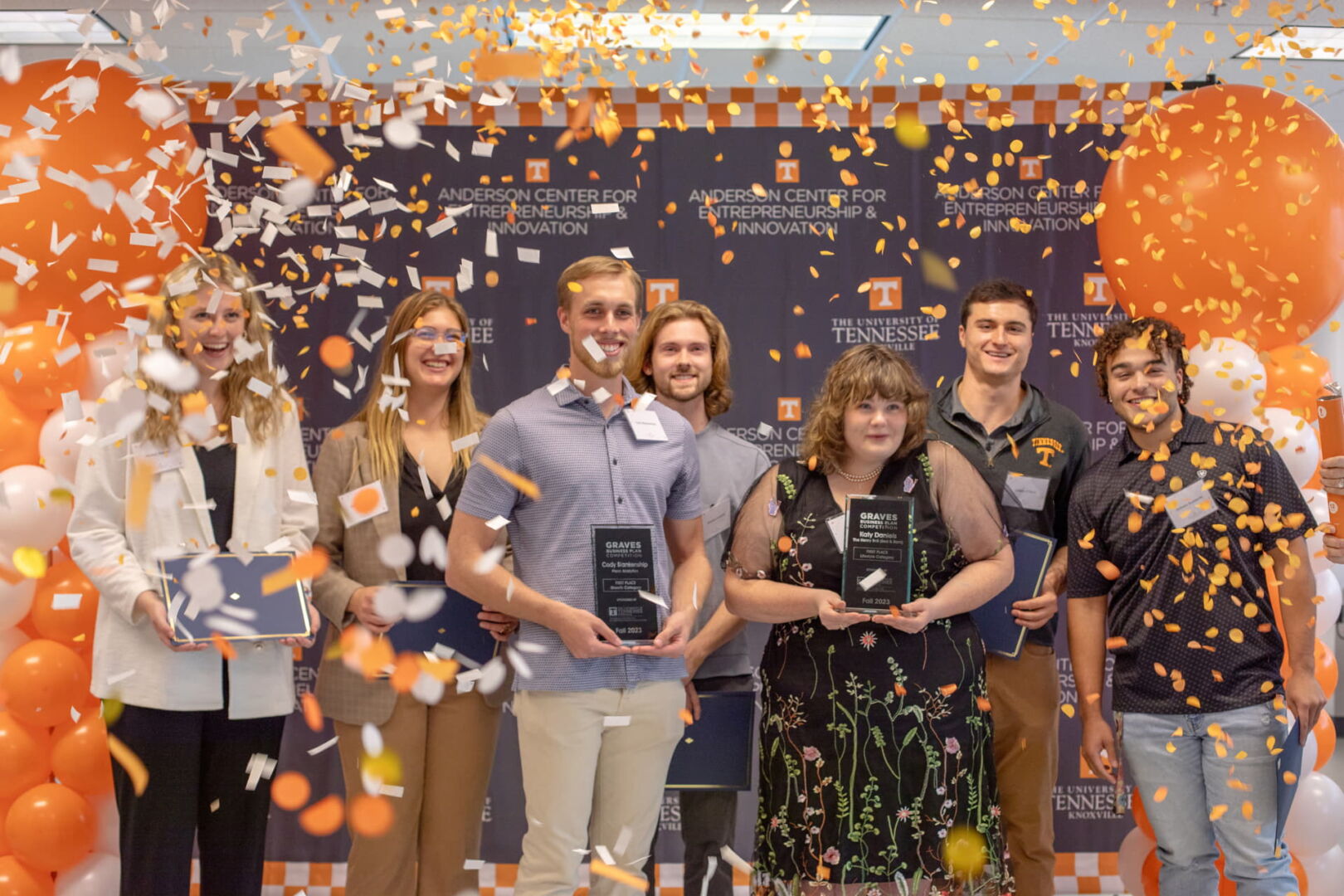 Group of award winners posing with trophy
