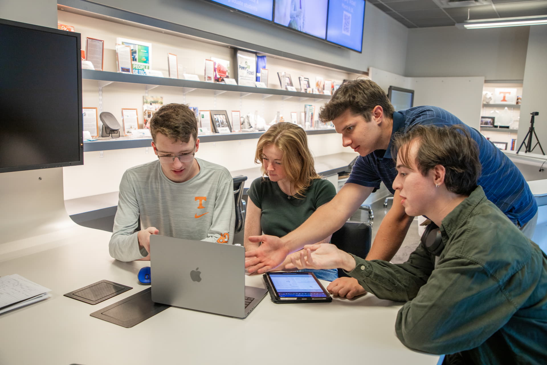 Group of students working on a laptop
