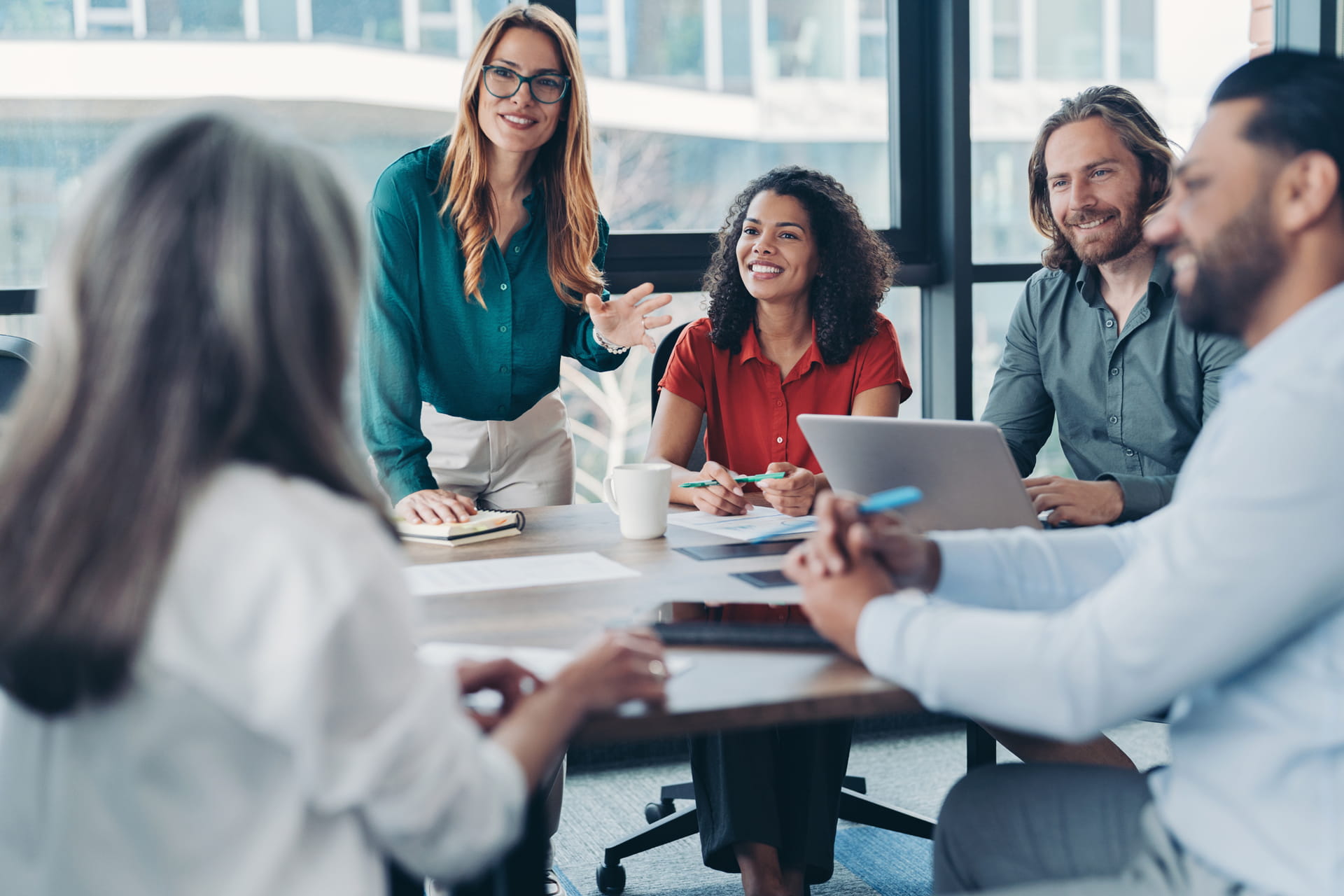 Group of people with project manager talking in the office