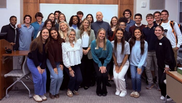 Students from Haslam marketing class 541, with Ron Matteotti in the back center and Christine White to the right and front of him, all in casual attire.