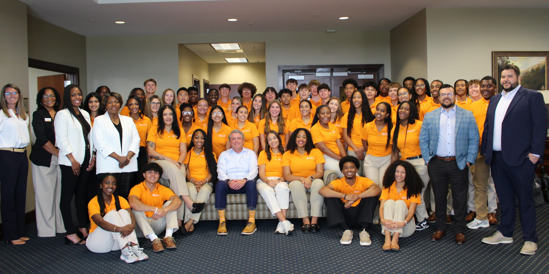 group of students, faculty and business leaders