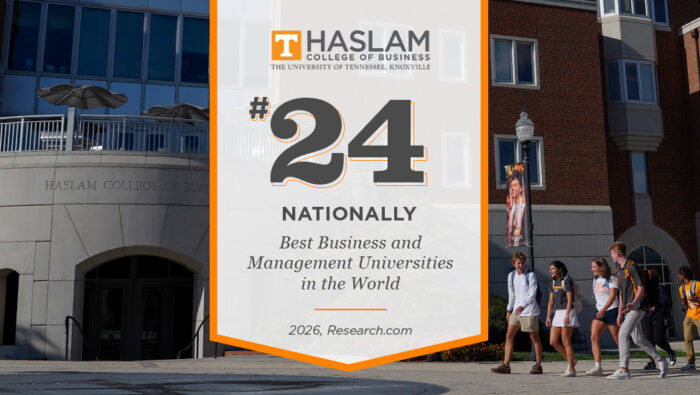 A perpendicular banner with orange trim and a white field has the Haslam logo and the words, "#24 Nationally Best Business and Management Universities in the World, 2026, Research.com" printed on it is superimposed on an image of the south facade of the Haslam Building with a group of students walking by on the right.