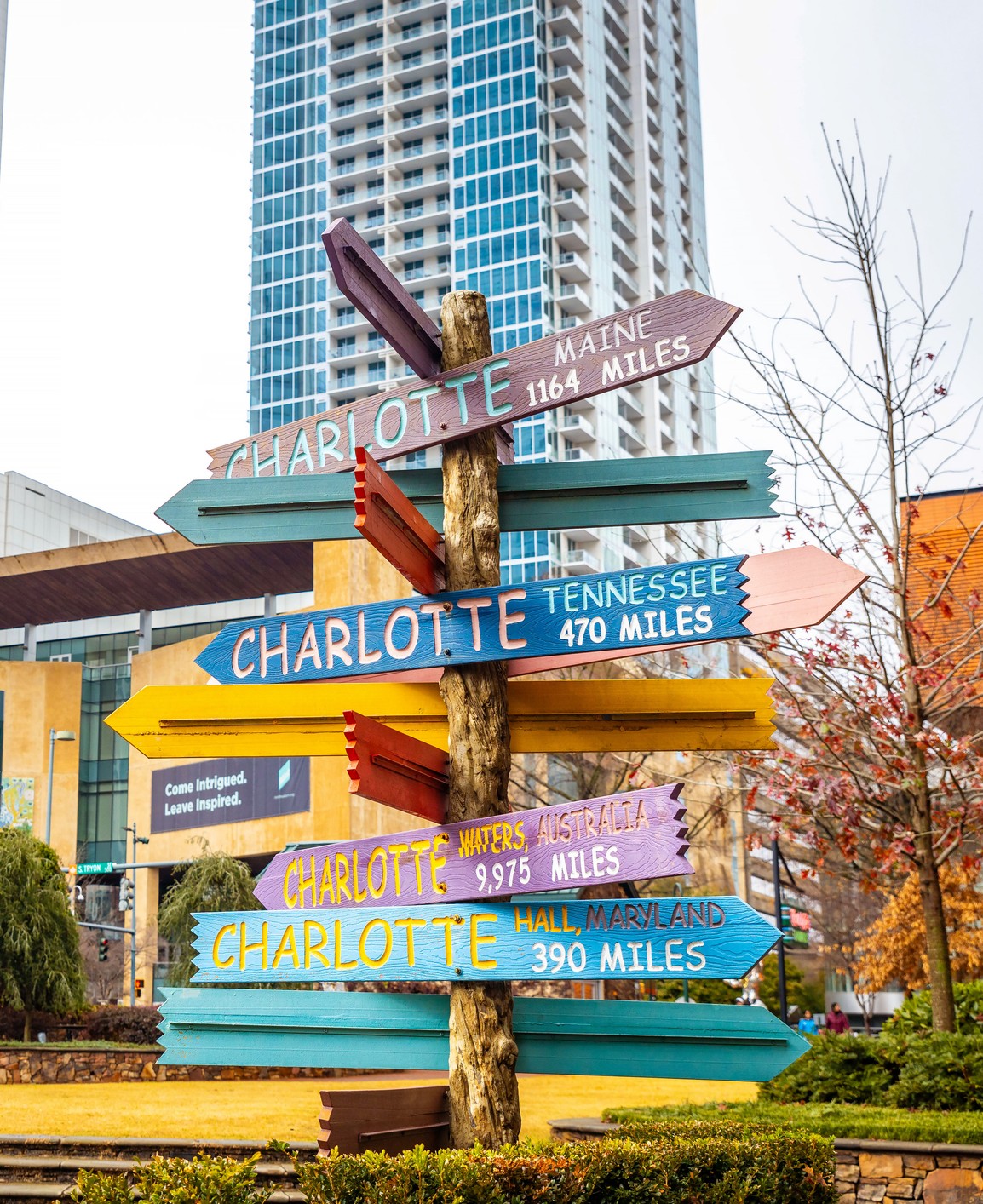 Colorful directions signs in Charlotte The Green city center park