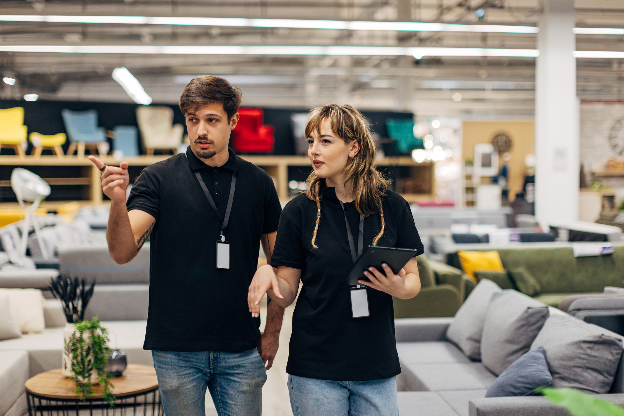 Two salespeople in a furniture store.