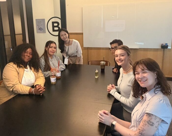 Spencer Marvel, bottom right, joins here fellow interns - all dressed casually - at a long meeting as the y prepare for their first day of work at Obze Korea Inc.