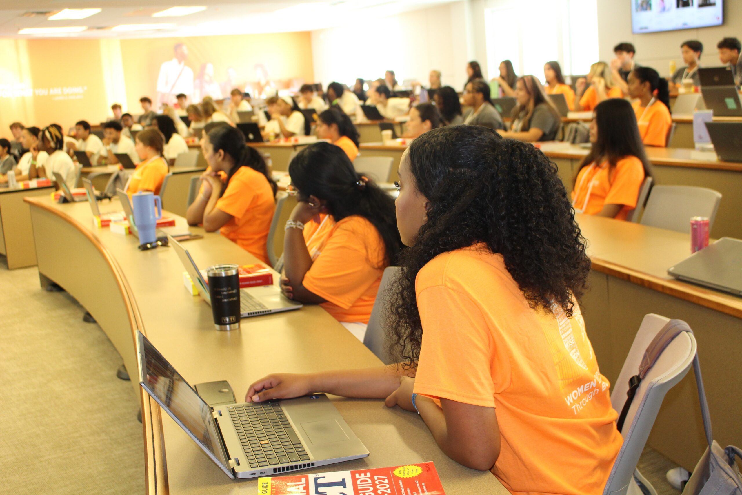 Summer program students listening to speaker in class